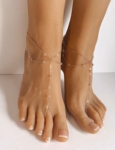 Amanda Rose Gold Barefoot Sandals are a stunning pair of barefoot sandals which features a minimalist design and barely there feel. Handcrafted using 1.5mm cable chain with tiny metal balls which are ingrained into the chain. Lobster clasp closure on the back of the sandals accommodates all foot sizes and does not restrict the movement of your feet. Wear them as a pair or individually. Perfect gift for a true minimalist. Sold as a pair. Gift Wrapped. Ships in 2 business days. All rights reserved Gold Barefoot Sandals For Summer Gift, Elegant Barefoot Sandals With Single Toe Strap For Beach, Summer Party Barefoot Sandals With Single Toe Strap, Elegant Open Toe Barefoot Sandals For Beach, Gold Ankle Wrap Barefoot Sandals For Summer, Adjustable Open Toe Gold Barefoot Sandals, Adjustable Toe Post Barefoot Sandals For Summer, Ankle Wrap Sandals As Summer Gift, Elegant Summer Ankle Wrap Barefoot Sandals