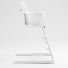 a white desk chair with a red button on the back and arm rests against a white background