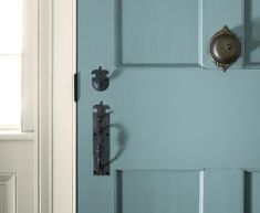 a blue door with two knobs on it