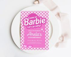 a pink and white plate with a card on it that says, come on barbie lets go party