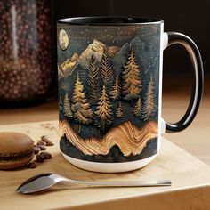 a coffee mug sitting on top of a wooden table next to a spoon and fork