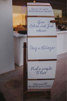 three signs are attached to the side of a wooden stand in front of a counter