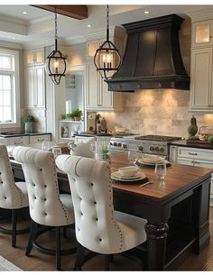 a large kitchen with an island in the middle and lots of chairs on top of it