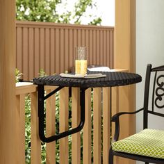 an outdoor table and chair on a balcony