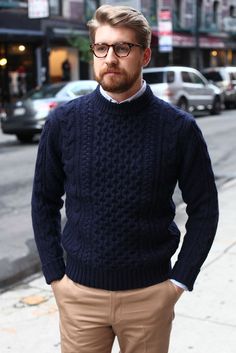 a man standing in front of a street with cars