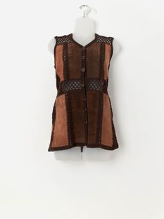 70s vintage faux suede crochet patchwork vest in brown. This 1970s vest features a stunning mixed brown crochet and patchwork pattern, a V-neck and a full length button closure. Made from a mid-weight synthetic material.  Our recommended size: Small to medium Label says: No size label Condition: Good. Some light marks on the front. Please see last image (not colour accurate)  Material: 100% acrylic Measurements in inches: Pit to pit: 17.5 Shoulders: 14 Front length: 27.5 Back length: 28 Hem: 20 Fitted Brown Bohemian Vest, Brown Patchwork Vest For Fall, Bohemian Brown Vest For Fall, Patchwork Vest, Patchwork Patterns, Vest Outfits, Womens Vest, Faux Suede, Full Length