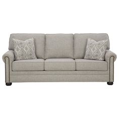 a gray couch with two pillows on it