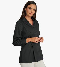 Unleash your confidence with our Diamond Tuck Shirt. Made from organic cotton poplin, this shirt features a flattering V-neckline and unique diamond tucks at the waist for a modern touch. Perfect for any occasion, this versatile style will be your new go-to! This is a limited production item produced in small quantities. If your selected size is currently sold out and pre-order is available, pre-order yours today to be first on the list for our next shipment. V-neck Cotton Shirt For Work, Versatile V-neck Work Shirt, Classic Cotton V-neck Shirt, Cotton V-neck Tops For Business Casual, Formal Cotton V-neck Blouse, Classic V-neck Cotton Shirt, Versatile V-neck Workwear Shirt, Relaxed Fit V-neck Office Shirt, Timeless Button-up Tops With Concealed Placket