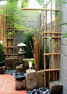 an outdoor garden with rocks and bamboo