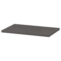 a black shelf that is on top of a white wall