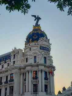 an ornate building with a statue on top