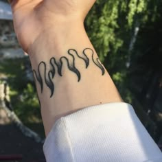 a woman's wrist with some black ink on it