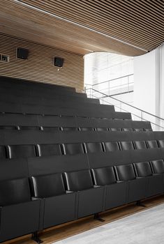 an empty auditorium with black leather seats