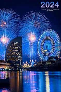 fireworks are lit up in the night sky over water and city buildings with lights on them