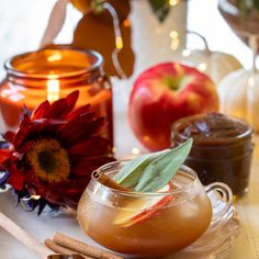 an apple cider with cinnamon and apples in the background