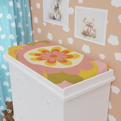 a baby's crib with pictures on the wall