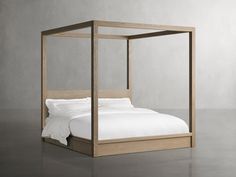 a bed that is made up with white sheets