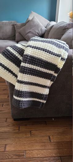 a striped blanket sitting on top of a couch