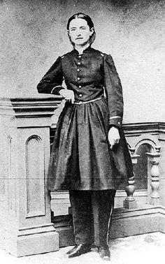 an old black and white photo of a woman in uniform