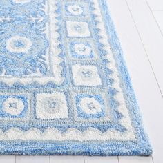 a blue and white rug on the floor