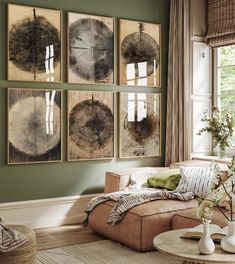 a living room filled with furniture and pictures hanging on the wall above a coffee table