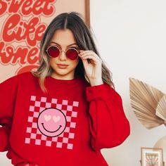 I'm glad you're looking for a pink smiley face heart eyes checkered print sweatshirt!   Want a matching tee for your little one? Grab it here: https://www.etsy.com/listing/1376721010/kids-pink-smiley-face-heart-eyes We have a variety of sizes and three colors (white, ash, red) to choose from, so you can find a sweatshirt that perfectly fits your style. This is such a cute design featuring the iconic heart eyes smiley face and is great to go in Easter baskets. The unisex heavy blend crewneck swea Trendy Pink Sweatshirt With Funny Print, Pink Smiley Face, Pink Smiley, Best Valentine Gift, Cricut Explore Projects, Valentine Sweatshirt, White Ash, Checkered Print, Checker Print