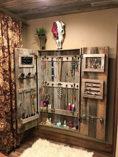 an old door is used as a jewelry storage unit in this rustic style home decor