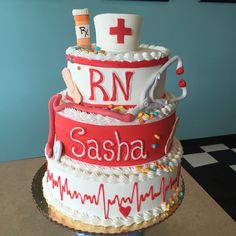 a three tiered cake decorated with medical related items