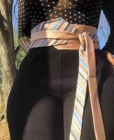 a woman in tight pants with a tie on her waist