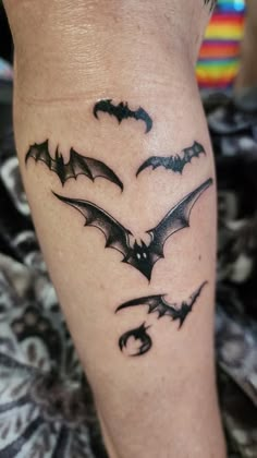 a person with a bat tattoo on their leg