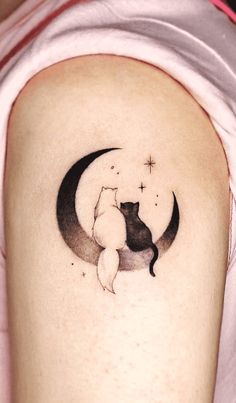 a cat is sitting on the moon tattoo