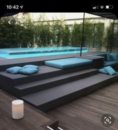 an outdoor living area with couches and a pool