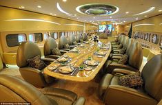 the inside of an airplane with many seats and tables set up for a formal meal