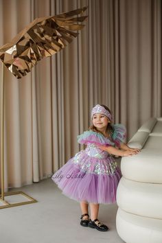 Make your little girl's birthday extra special with this gorgeous  Mermaid Dress! This stunning toddler birthday outfit features a beautiful mermaid-inspired design with a flowing lilac tutu skirt and a mermaid detail. The dress is perfect for any special occasion, including birthdays, cake smashes, and princess-themed parties. Made with high-quality materials, this baby girl tutu dress is soft, comfortable, and breathable, ensuring that your little one stays cozy and stylish all day long. Wheth Whimsical Purple Princess Dress With Ruffles, Pink Ruffled Mermaid Dress For Pageant, Pink Mermaid Dress With Ruffles For Pageant, Pink Tulle Mermaid Dress For Pageant, Pink Tulle Mermaid Dress For Pageants, Whimsical Mermaid Dress For Party, Purple Fairy Dress With Ruffles For Birthday, Whimsical Mermaid Tutu Dress For Birthday, Whimsical Purple Princess Dress For Pageant