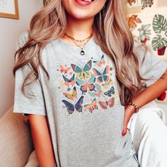 🦋Unleash the beauty of butterflies with our Butterfly Bliss T-Shirt! This enchanting design showcases elegant butterflies, radiating grace and transformation. Embrace the magic of nature and add a touch of whimsy to your style. Perfect for butterfly enthusiasts seeking a fashion-forward and nature-inspired tee🦋 How to order? 🧐 ✓Review all images in this listing for style, color, and sizes. ✓Select the size and color of the Item from the drop-down menus. ✓Add to cart 🔥 UNISEX 🔥 ✓ Light fabri Summer Graphic Tee With Butterfly Print, Trendy Short Sleeve T-shirt With Butterfly Print, Trendy Cotton T-shirt With Butterfly Print, Cute Butterfly Print T-shirt For Spring, Trendy Butterfly Print Crew Neck Tops, Trendy Crew Neck Tops With Butterfly Print, Cotton Tops With Floral Print And Butterfly Sleeves, Spring Graphic Tee With Butterfly Print, Cute Summer T-shirt With Butterfly Print