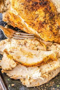 a close up of chicken on a plate with a fork