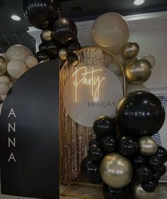 a birthday sign surrounded by balloons and streamers in an office setting with the words party written on it