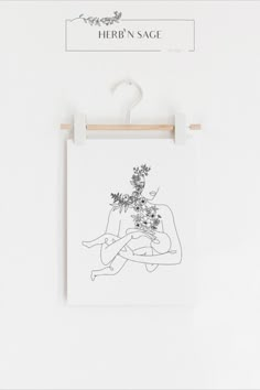 a black and white drawing hanging on a wall next to a sign that says herb'n sage