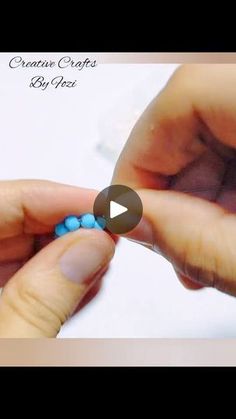 a person is holding some beads in their hands