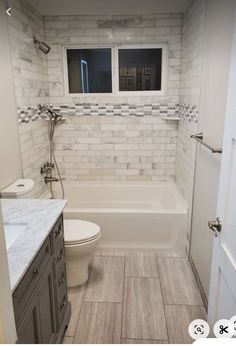 a bathroom with a toilet, sink and bathtub