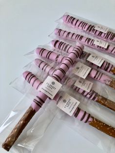 six pink and brown candy sticks wrapped in cellophane