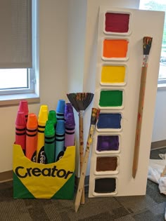 there are many crayons and paint in the holder