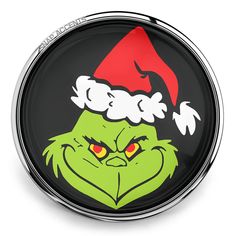 the grin face is wearing a santa's hat with red eyes and green hair