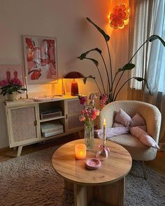 a living room filled with furniture and flowers on top of a wooden table in front of a window