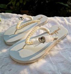 Description The beautiful rhinestone and customizable Flip Flops for the beach brides, bridesmaids, vacation, honeymoon or any occasion you desire to look gorgeous. Perfect in any outfit! Being unique and stunning on design, these flip flops must be your must-have item! The sandal is anti-slip, comfortable and durable as it is made from high quality rubber from the South of Thailand, where is famous for the best rubber tree. Moreover, the crystals are decorated on the sandal with effective adhes Elegant Adjustable Flip Flops For Beach, Adjustable Sandals With Rhinestones For Beach Season, Elegant Open Toe Beach Flip Flops, Elegant Open Toe Flip Flops For The Beach, Summer Bridal Shower Sandals With Round Toe, Open Toe Sandals For Beach Wedding, Open Toe Sandals For Beach Season Weddings, Beach Wedding Open Toe Sandals, Adjustable Embellished Flip Flops For Summer