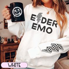 This cozy sweatshirt is the perfect gift for the elder emo in your life. Each sweatshirt has a checkered lightning bolt on the outer lower left sleeve as pictured. This crewneck sweatshirt is pure comfort. Made from a soft cotton/poly blend with no itchy side seams, this is sure to become a staple. SIZE AND FIT: Your sweatshirt design will be printed on a high-quality, soft and comfortable unisex sweatshirt. Sizes run true to size, which takes the guesswork out of ordering; if you like your swea Emo Letter Print Sweatshirt For Streetwear, Emo Crew Neck Sweatshirt For Streetwear, White Punk Cotton Sweatshirt, White Cotton Punk Sweatshirt, White Cotton Punk Style Sweatshirt, Emo Letter Print Sweatshirt For Fall, Punk Letter Print Sweatshirt For Concert, Punk Style Letter Print Sweatshirt For Concert, White Punk Sweatshirt For Winter