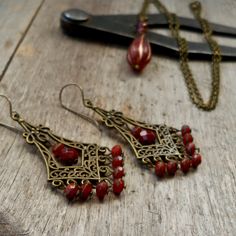 The little rustic orange beads on these earrings, are what started the whole thing! These earrings are a little pop of color for your ears in my same rustic boho style. I have other items listed and there are probably going to be more. I love these little beads.  This listing is for the chandelier earrings only. The other items are listed separately. The beads on these are 3 x 5mm in size. They are high quality Czech glass. The ear wire, as shown, is a pure titanium ear wire. Titanium is perfect Ruby Aesthetic, Raw Garnet, Rustic Orange, Indie Jewelry, Titanium Earrings, Rustic Boho, Lake Forest, Garnet Earrings, Colorful Earrings