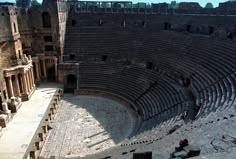 an aerial view of the roman amphit, with people sitting on the seats and looking at the floor