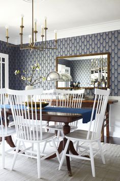 a dining room with blue and white wallpaper