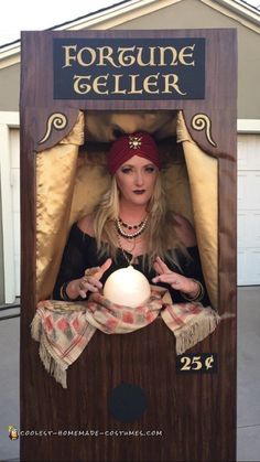 a woman dressed as a fortune teller with her hands in the air and holding a ball